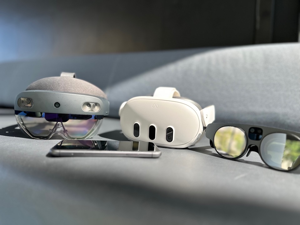 A collection of various XR headsets and a phone